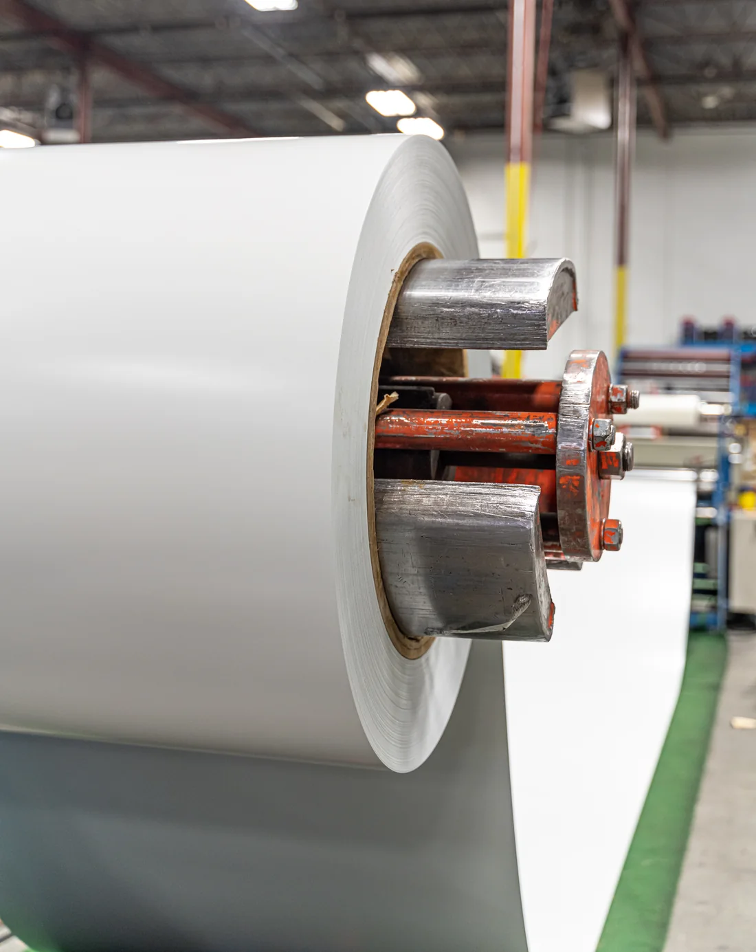 A coil of white coated sheet on the line’s decoiler